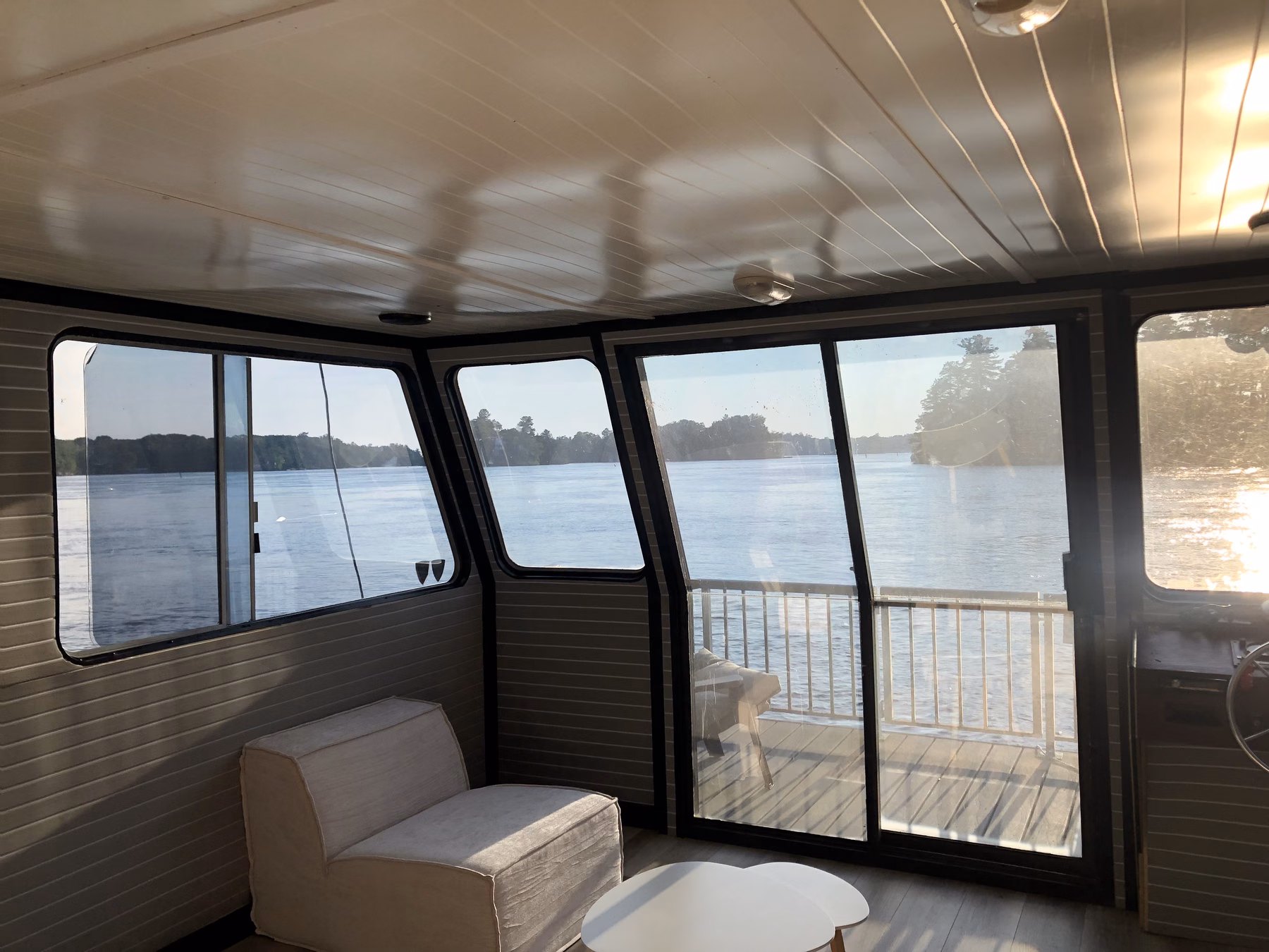 Houseboat lounge with broad windows facing the river
