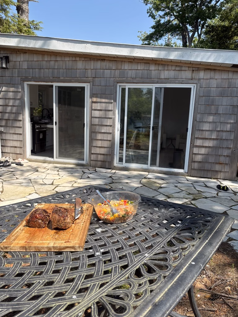 A meal set out on the patio beside the houseboat